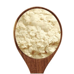  A spoonful of potato flakes on a white background .