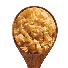  A spoonful of potato dices on a white background .